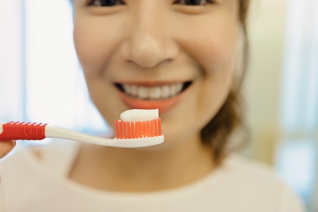 A young man demonstrating tartar removal toothpaste