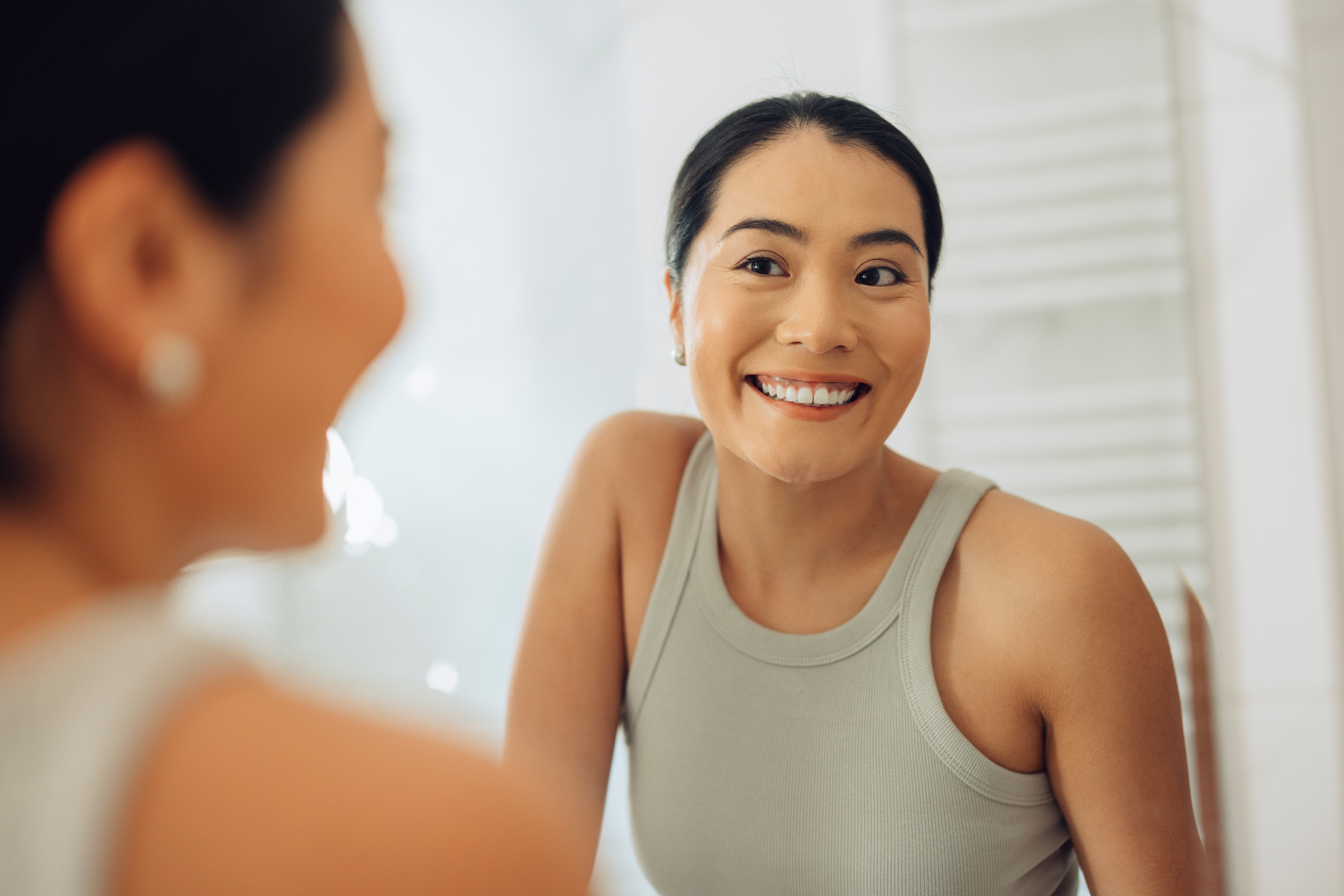 A girl smiling, showcasing whiten teeth at home