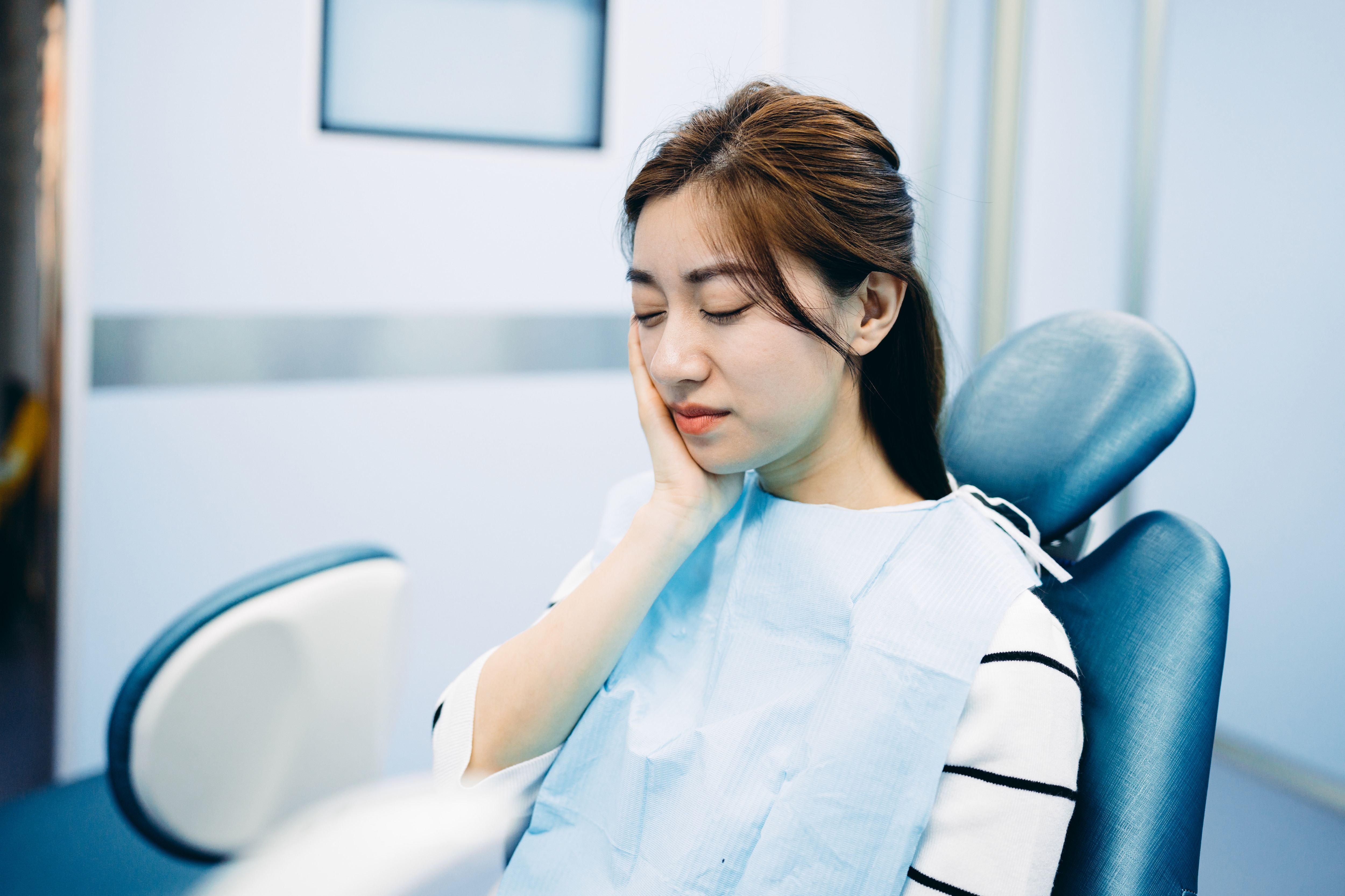 Man in pain due to receding gums disease 