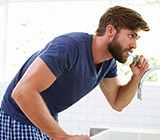 Young man brushing his teeth